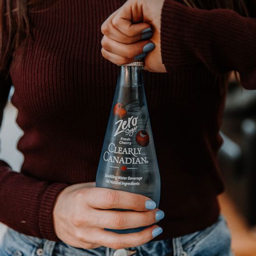 Clearly Canadian - Four 325ml Bottles of All Four Flavours On a Rock by a Mountain Stream